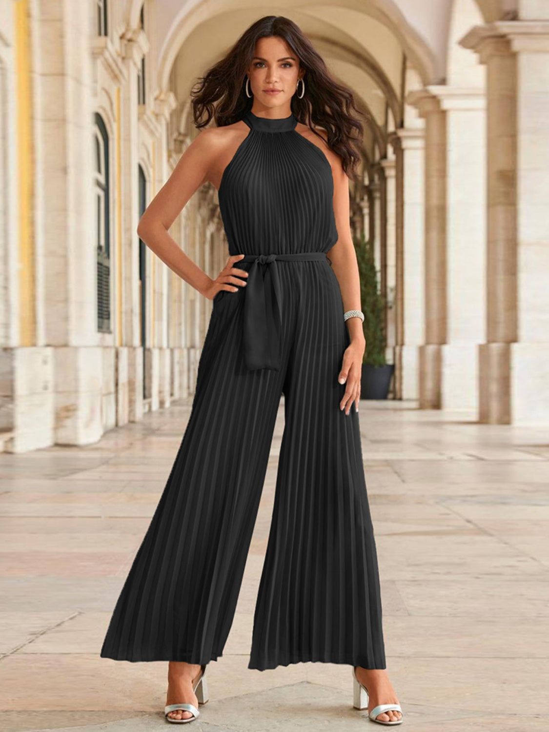 Black halter neck pleated palazzo jumpsuit with belted waist.