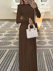Brown ruched knot front maxi dress with long sleeves and a round neckline.