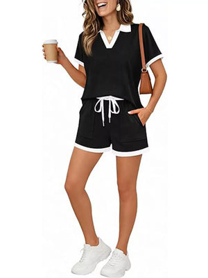 Black polo collar two-piece set with white trim, drawstring shorts, and pockets.