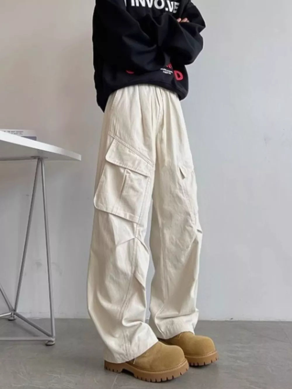 Relaxed fit apricot cargo pants with multiple pockets and drawstring waist.