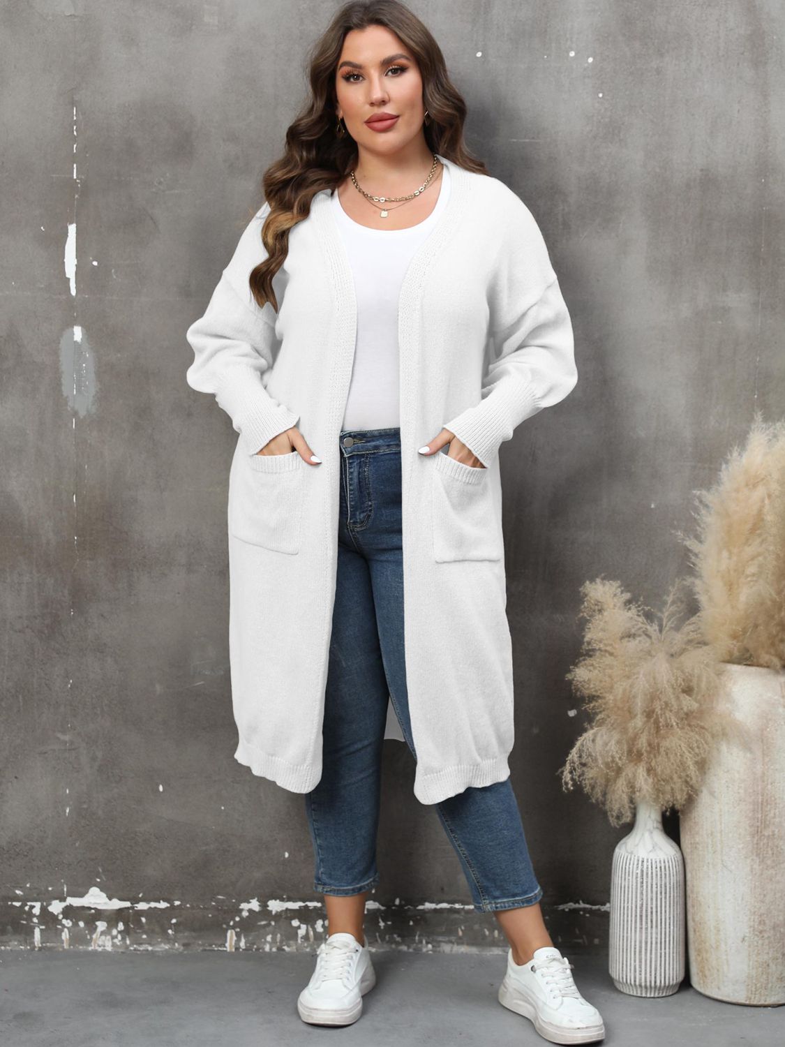 White oversized knit duster cardigan with patch pockets and a relaxed fit.