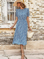 Blue floral puff sleeve midi dress with a slit, cinched waist, and round neckline.
