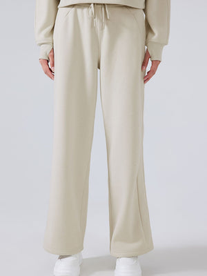 Relaxed palazzo sweatpants in beige with drawstring waist and wide leg