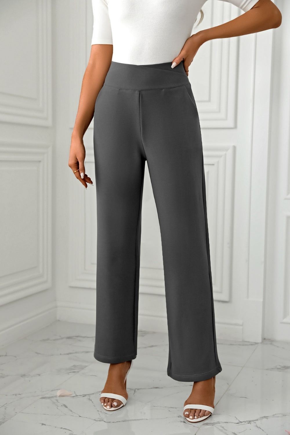 Dark gray wide-leg trousers with a sculpted waist and a relaxed fit.