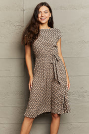 Geometric print midi dress in camel with short sleeves and a tie waist.