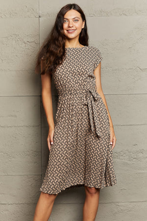 Geometric print midi dress in camel with short sleeves and a tie waist.