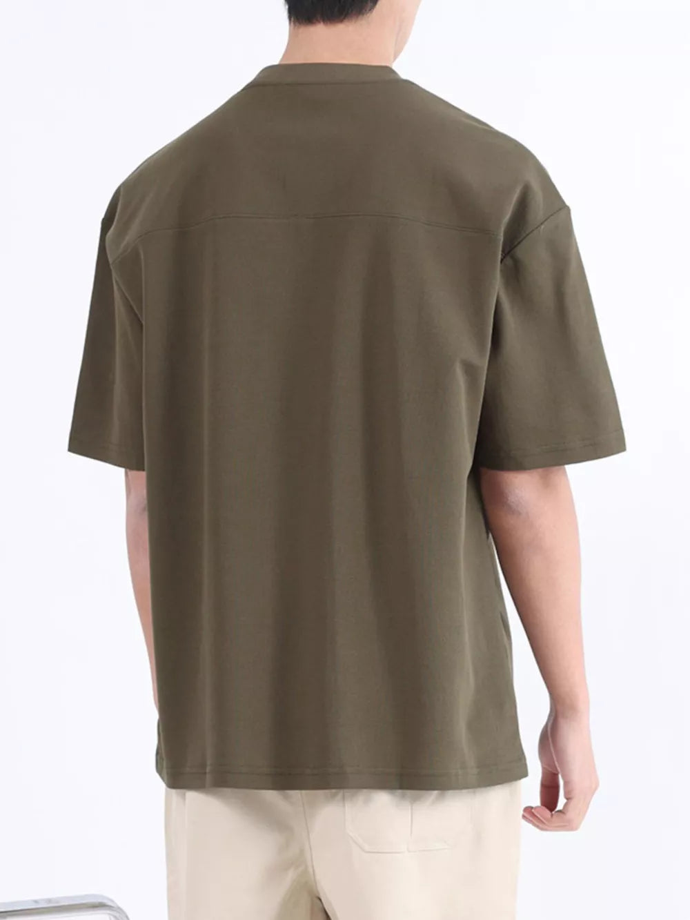 Men's dark green cotton t-shirt with short sleeves and a boxy fit.