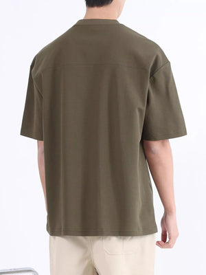 Men's dark green cotton t-shirt with short sleeves and a boxy fit.