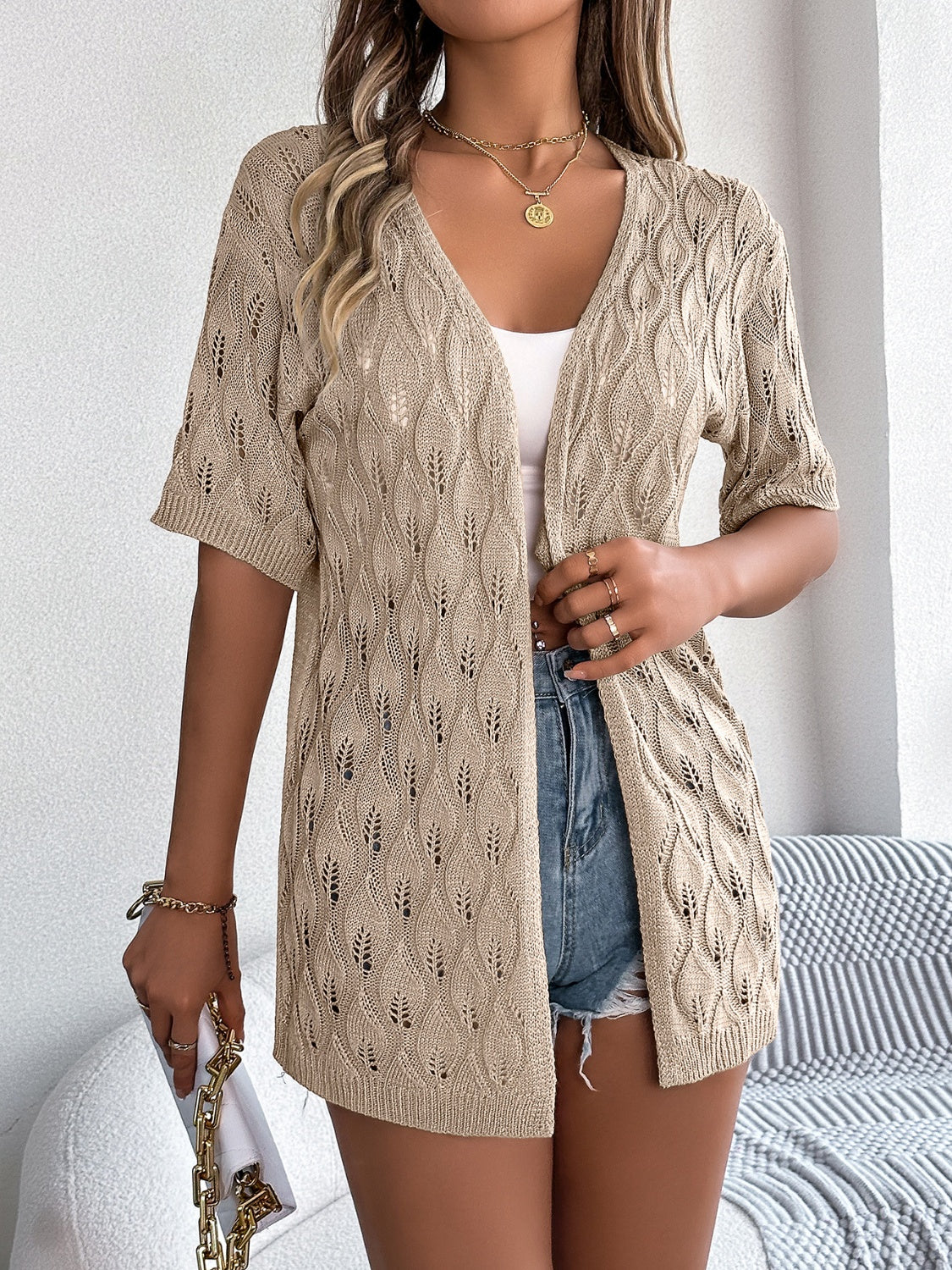 Tan open-knit short sleeve cardigan with leaf motif and V-neck.