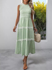 Green striped midi dress with smocked bodice and lace trim, sleeveless with ruffled neckline