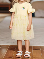Yellow baby dress with rainbow applique, ruffled sleeves, and tulle skirt with heart pattern.