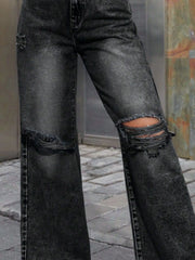 Distressed wash dark gray wide leg jeans with ripped knees.