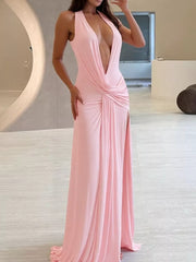 Pink ruched halter neck maxi dress with a deep V-neck and thigh-high slit.
