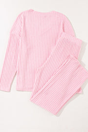 Blush pink ribbed V-neck loungewear set with long sleeves and matching pants.