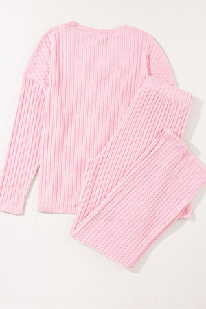 Blush pink ribbed V-neck loungewear set with long sleeves and matching pants.