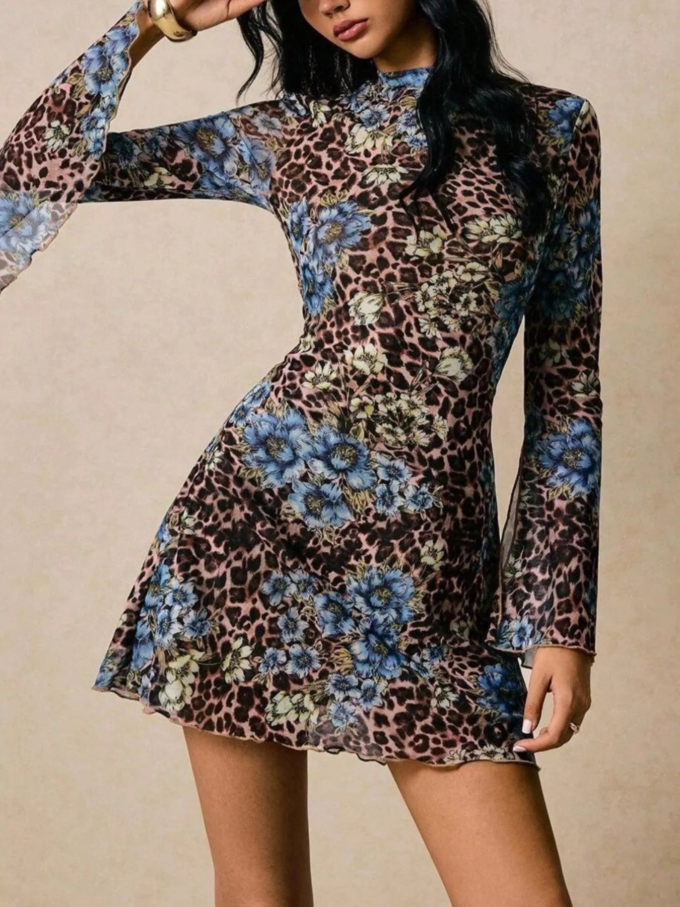 Mini dress with mock neck, bell sleeves, and floral leopard print.