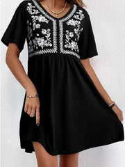 Black embroidered floral v-neck mini dress with short sleeves.