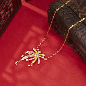 Starburst pendant necklace with celestial charms, 18k gold, pink and yellow enamel, and cubic zirconia accents.