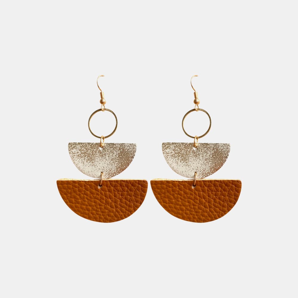 Textured leather and metallic half-moon earrings in caramel and gold.