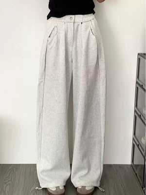 Men's gray wide-leg sweatpants with adjustable drawstring hem and pockets.