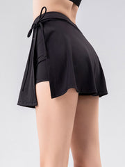 Black wrap-detail skort with side tie and built-in shorts.