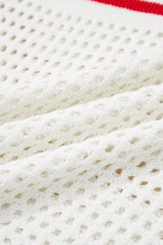 White eyelet knit sweater with red stripe detail, cap sleeve, acrylic.