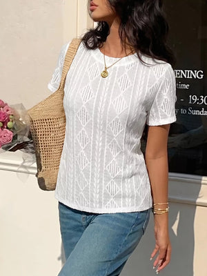 White textured knit maternity t-shirt with crew neck and short sleeves, featuring a diamond pattern and subtle bow detail.