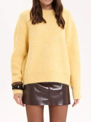 Cozy knit sweater in pastel yellow with relaxed fit and crew neck.