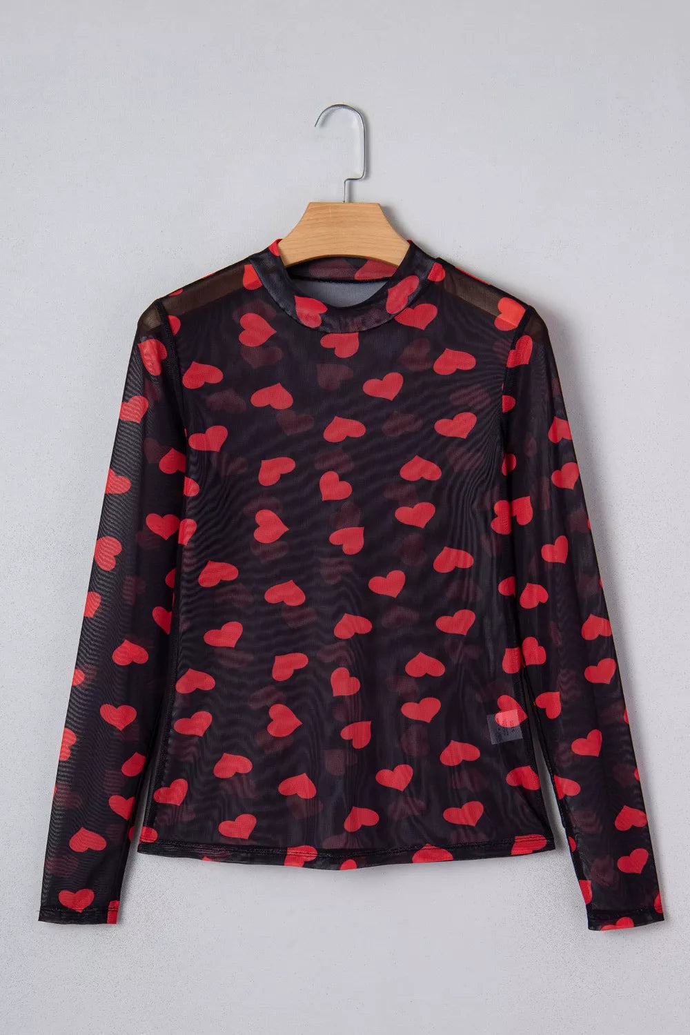 Black sheer mesh long sleeve top with all-over red heart print and mock neck.