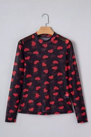 Black sheer mesh long sleeve top with all-over red heart print and mock neck.
