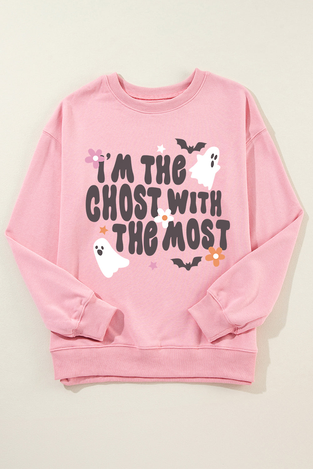 Blush pink crewneck sweatshirt with a spooky ghost and bat graphic and text that reads "I'm the ghost with the most.