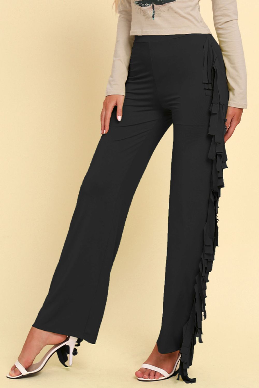 Black palazzo trousers with cascading fringe detail on the side.