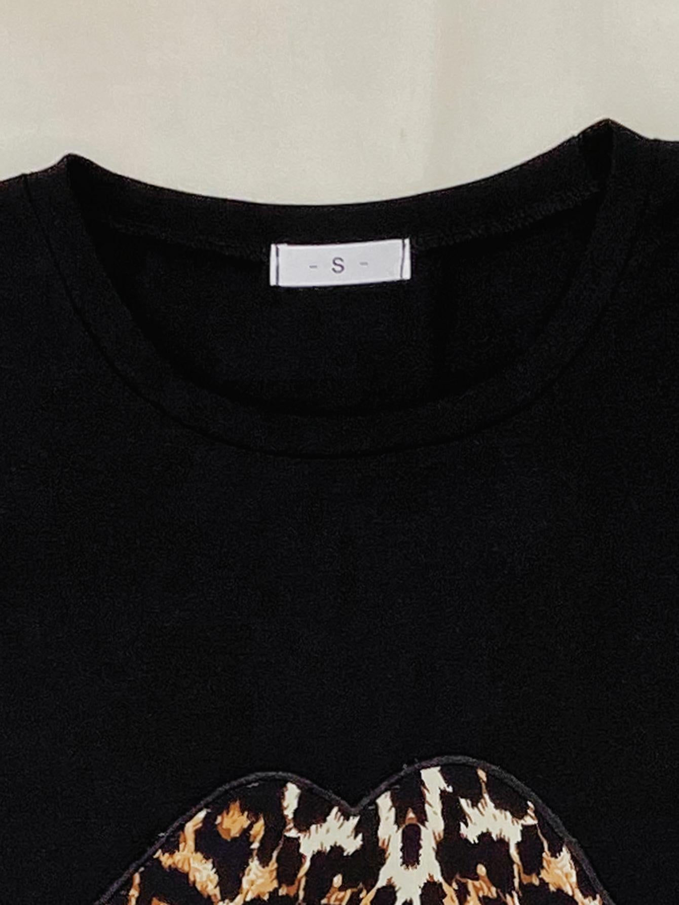 Black leopard lip tee with crew neck and short sleeves.