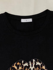 Black leopard lip tee with crew neck and short sleeves.