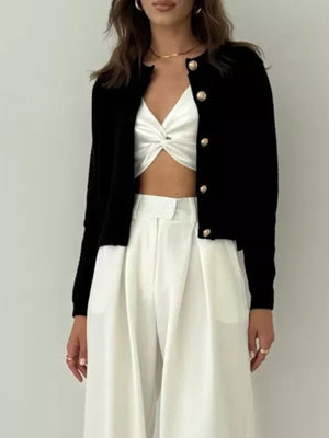 Black textured knit cardigan with gold button detail and crew neck.