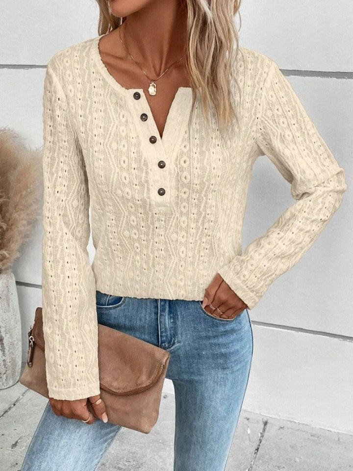 Cream textured henley long sleeve top with button detail and open knit pattern.