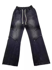 Distressed black wide-leg jeans for men with drawstring waist and studded panel details.