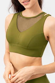 Matcha green performance bra top with mesh inset neckline and V-neck detail.