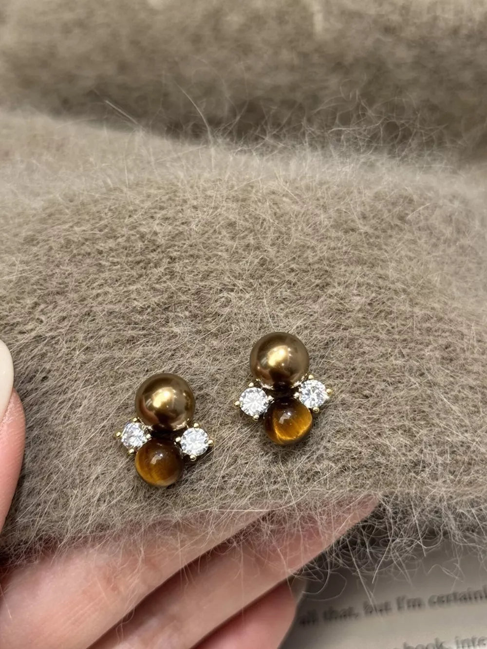 Spherical tiger eye stone stud earrings with clear accents and a cluster design.