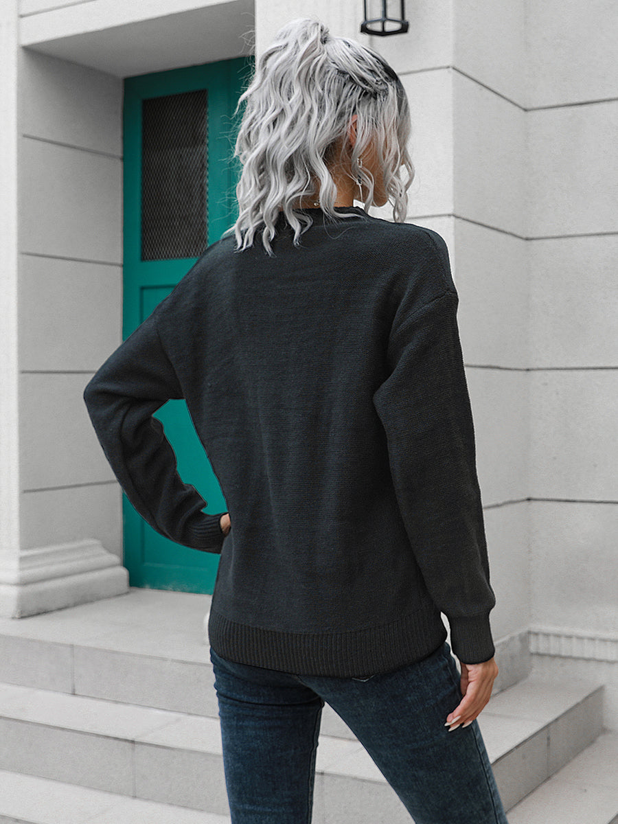 Black acrylic knit sweater with button detail and crew neck, casual style.
