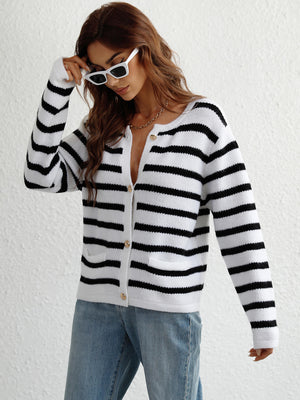 White and black horizontal stripe knit cardigan with pockets and button front.