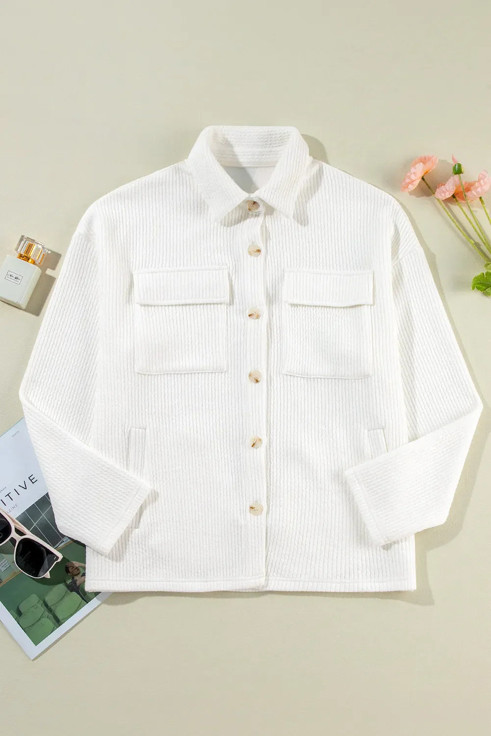 White textured corduroy overshirt with patch pockets and button front.