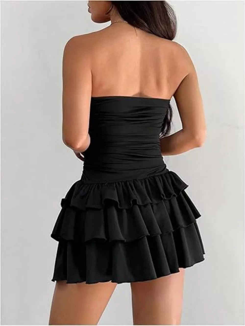 Black ruched strapless mini dress with tiered ruffle skirt