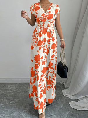 Floral surplice maxi dress in orange-red with cap sleeves and smocked waist.
