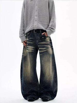 Men's vintage wash wide leg jeans in dark blue denim with distressed details.