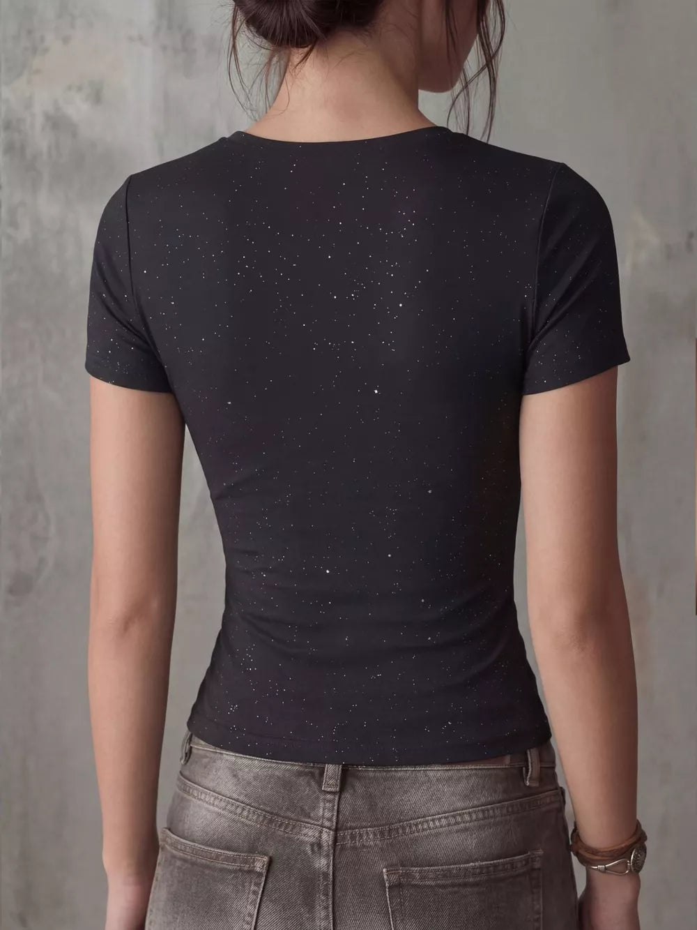 Black fitted t-shirt with short sleeves and a subtle sparkle detail.