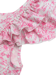 Maternity shirt with pink floral print, ruffled sleeves, and smocked neckline detail.