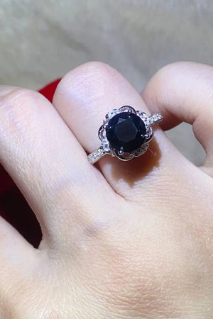 Black moissanite ring with diamond halo and floral band detail