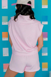 Pink gingham two-piece set with collared zip-detail top and drawstring shorts.