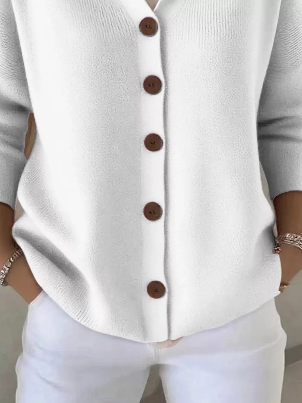 White button-front knit cardigan with brown buttons and 3/4 sleeves.
